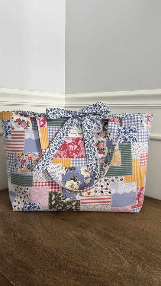 Handmade By Samantha XL Tote Bag: Multicolored Patchwork Floral With Bow Tie Closure and Navy Blue Ditsy Floral Lining